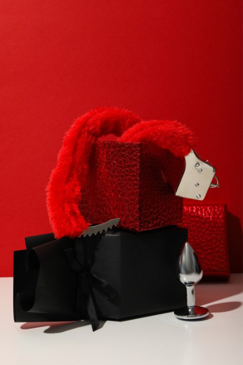 A set of sex toys in a heart-shaped box.